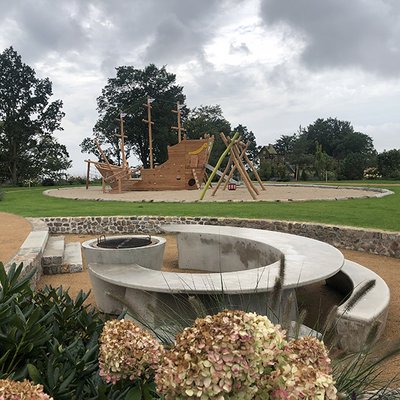 Stylischer Grillplatz aus Beton mit viel Platz zum Sitzen, Spielen und Genießen